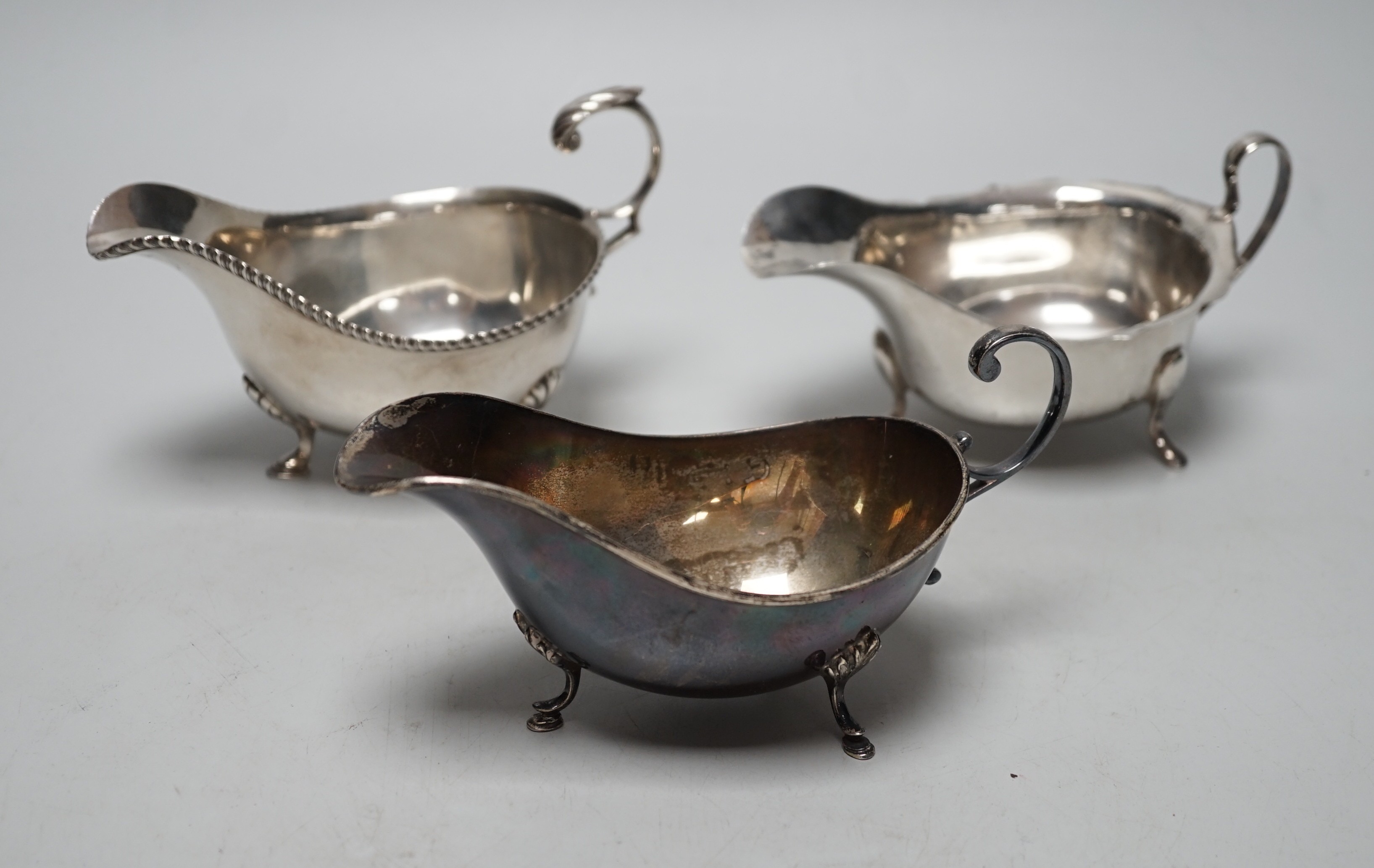 Three assorted 20th century silver sauceboats, longest 14.2cm